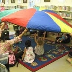 Students with umbrella in classroom