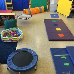 Classroom play area containing multi-colored equipment